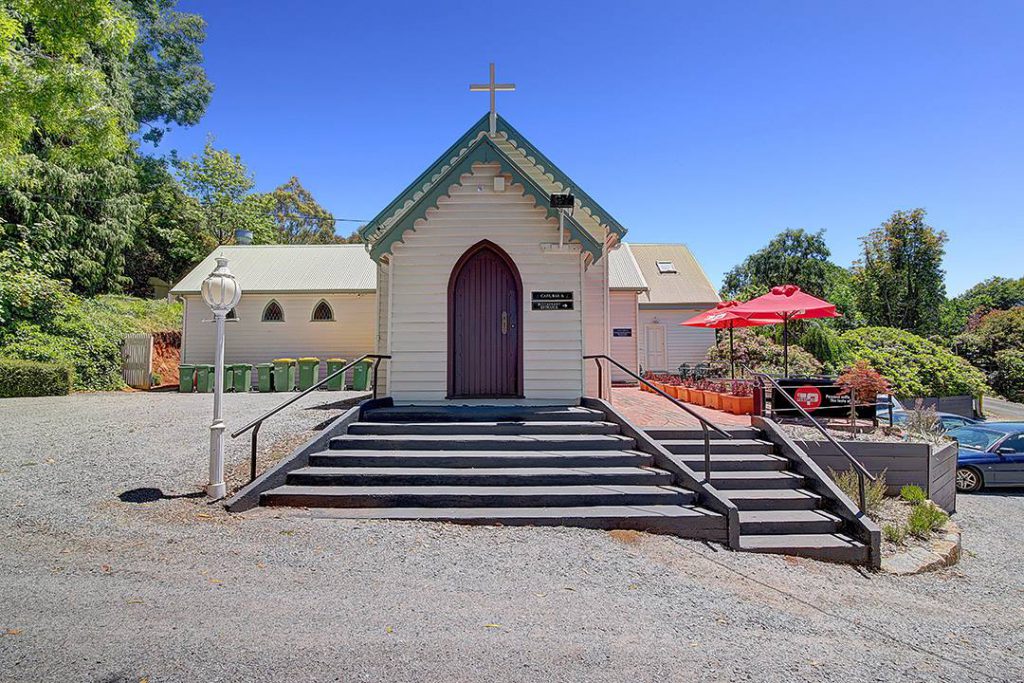 Dine Divine indoor chapel surrounded by towering trees at Dandenong Ranges