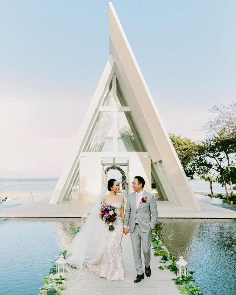 A couple walking on a floating wedding alley