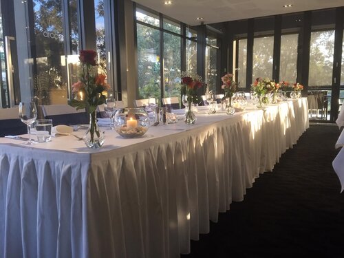 Wedding reception table set up with flower vases at Arco Restaurant