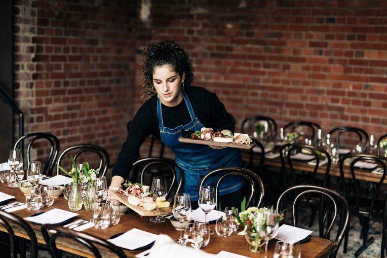 A waitress is preparing wedding set up at Pilgrim Bar