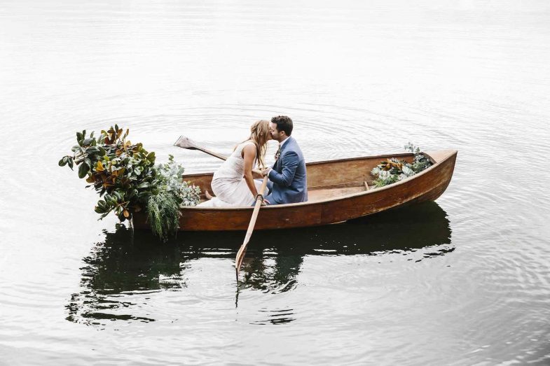 A wedding couple on a decorated wedding boat on a lake