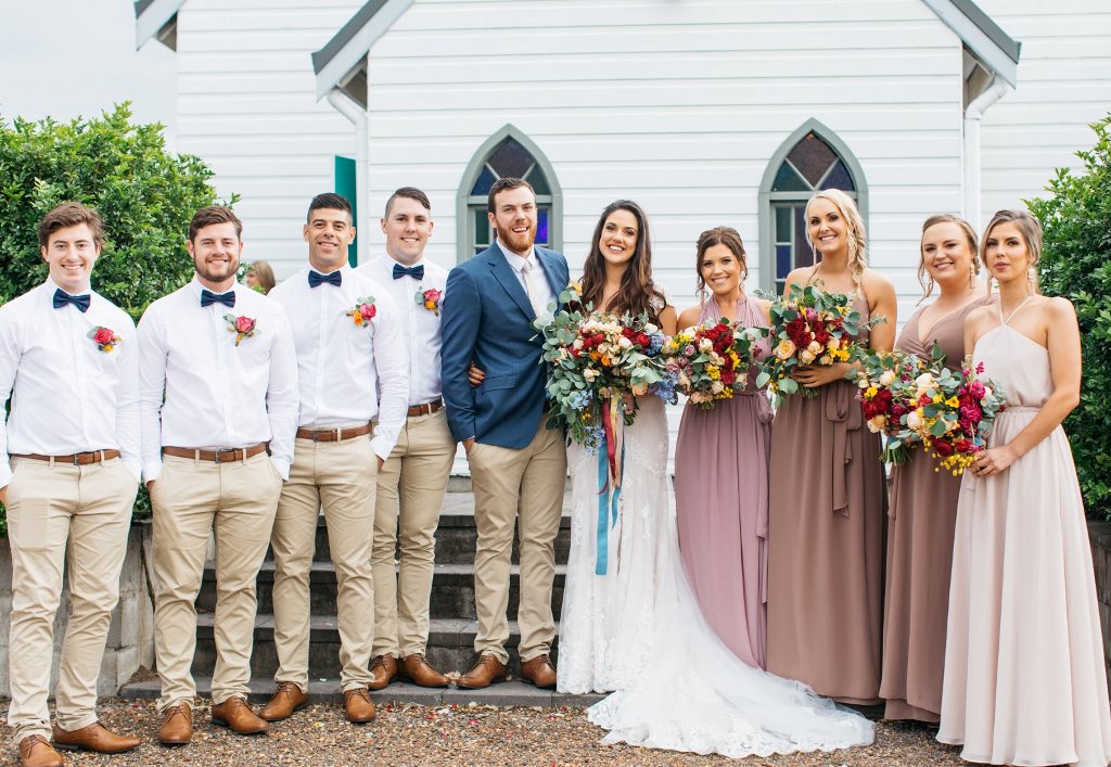 Amazing Rustic Wedding Venues in Hunter Valley -Lovedale Wedding Chapel Wedding couple, bridesmaids, and groomsmen in front of the chapel
