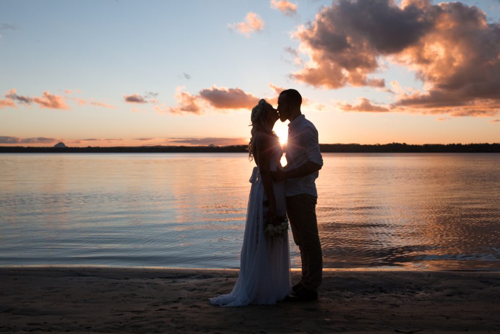 A wedding couple silhouette at the beach during sunset