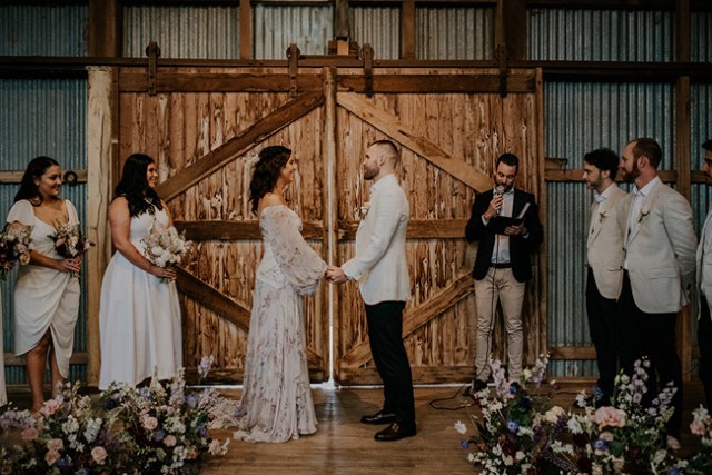 Exchanging a wedding vow in a tin barn