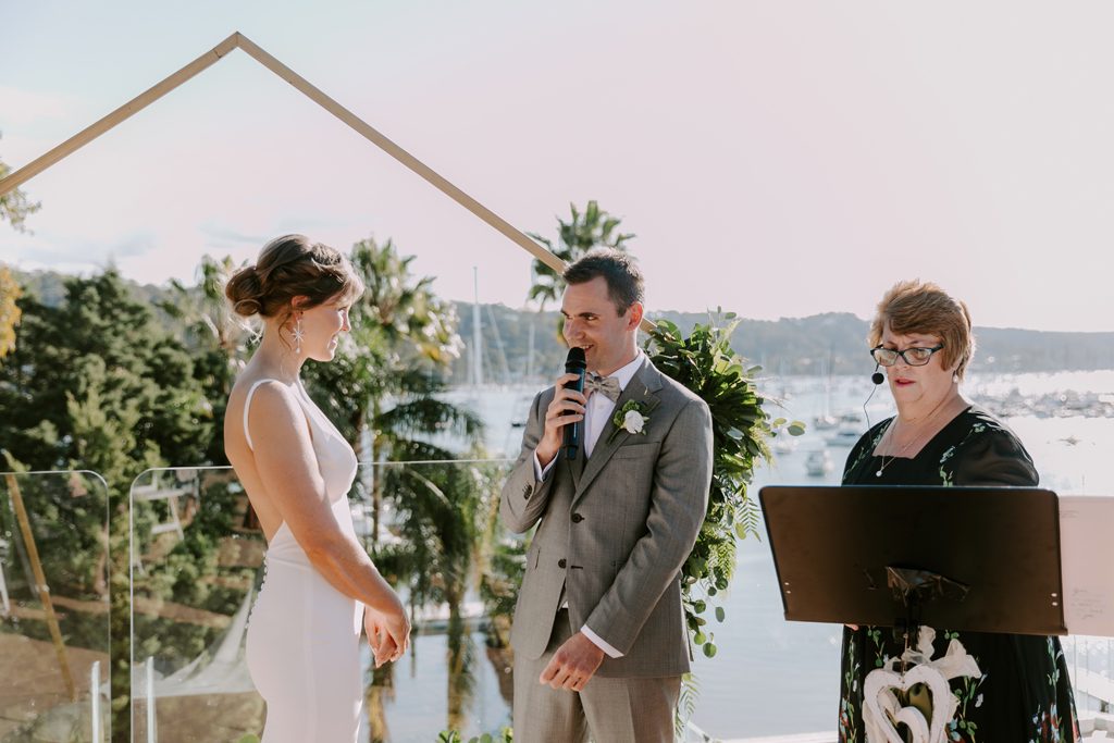 A couple is exchanging vows with Sydney port as a backdrop